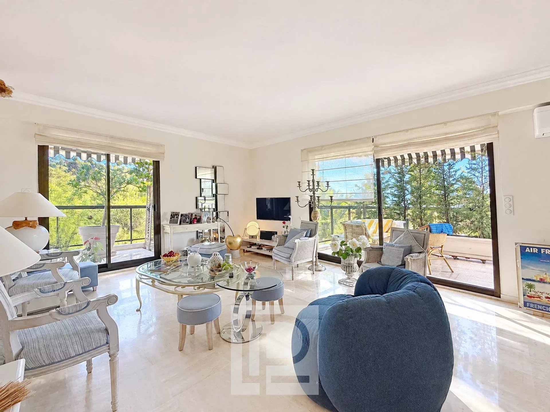 Bright apartment in Cannes Interior of a bright apartment with living room, windows overlooking a green park.