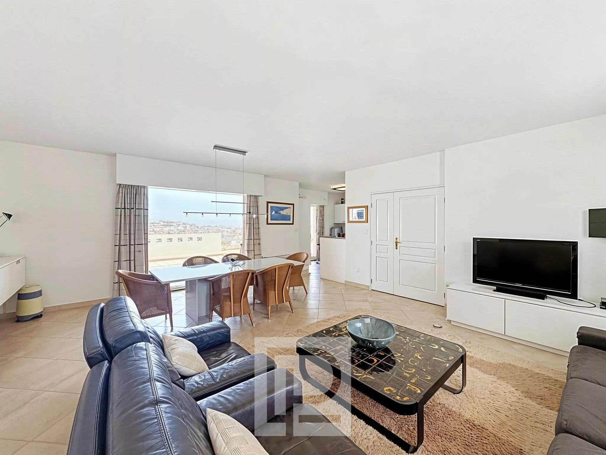 Modern apartment in Cannes Interior of a modern apartment with living room, dining room and open kitchen in Cannes.