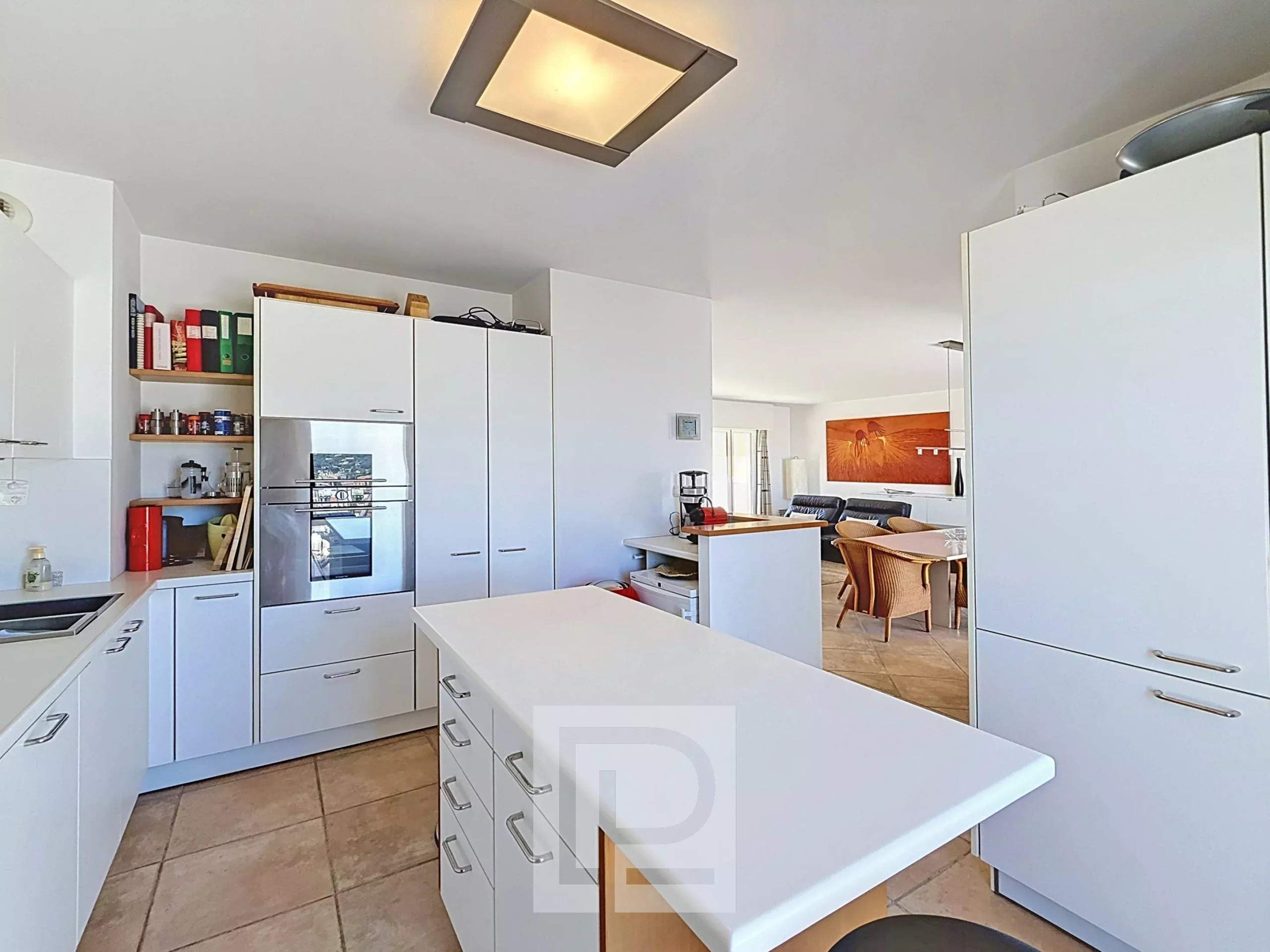 Apartment kitchen in Cannes Modern kitchen in a Cannes apartment with central island and storage.