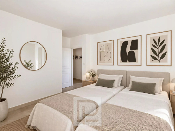 Room in a Cannes apartment with two separate beds and modern decor.