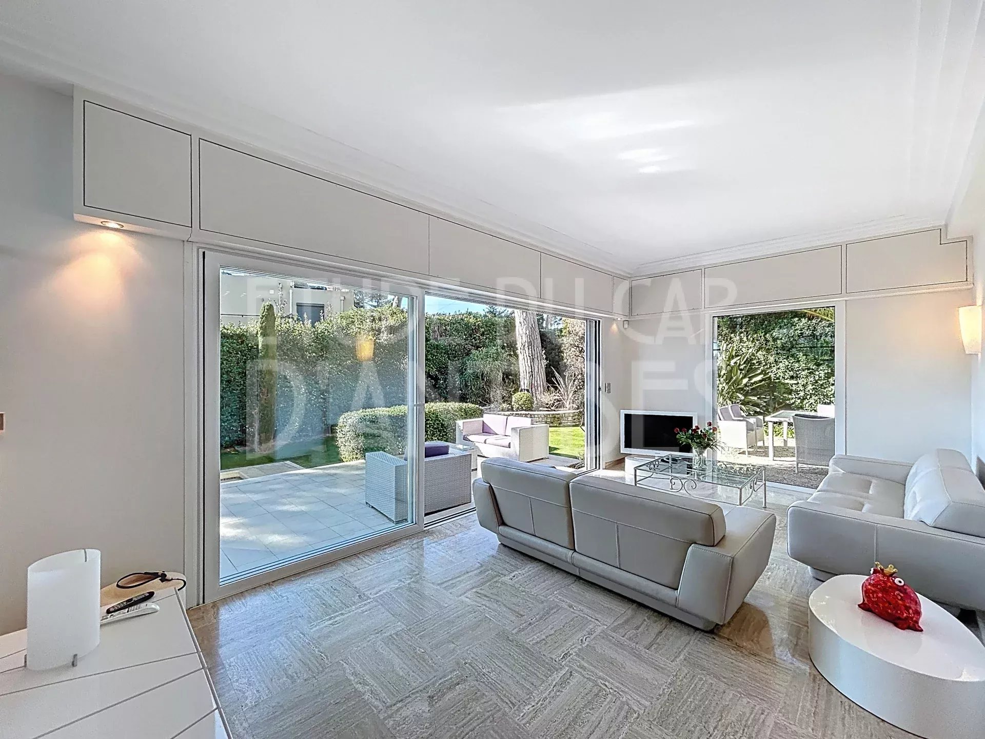 Living room of the villa in Antibes Interior of a modern villa with a bright living room and access to a terrace and garden.