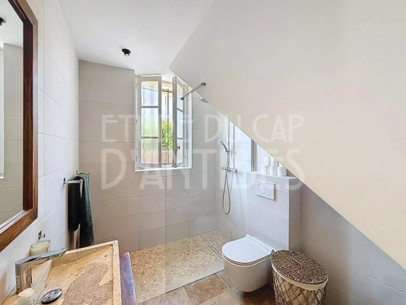 Modern bathroom with shower, sink and toilet in a house in Antibes.