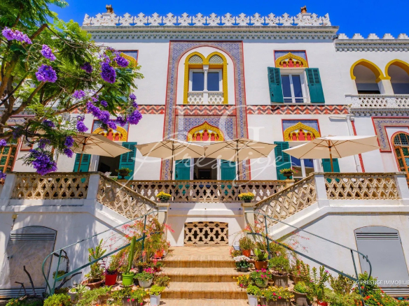 Historic style property with garden and parasols in Cannes, France.