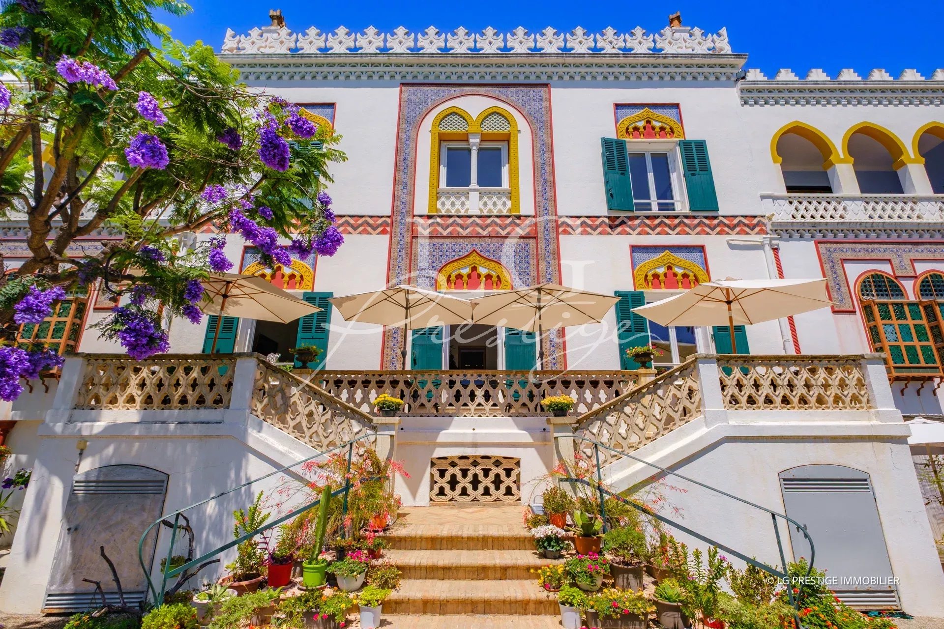 Historic style property with garden and parasols in Cannes, France.