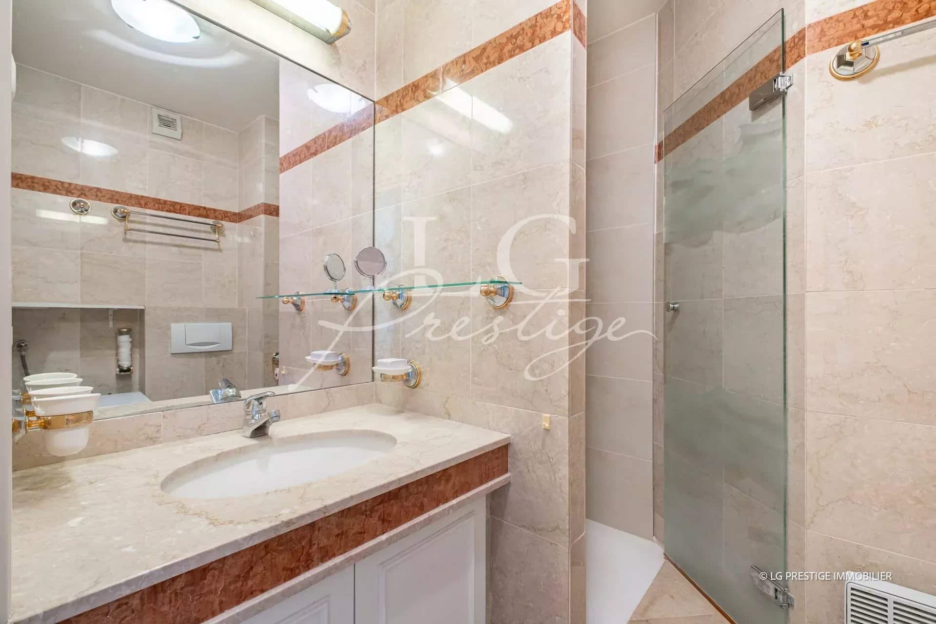 Modern bathroom with shower and sink in an apartment in Théoule-sur-Mer.