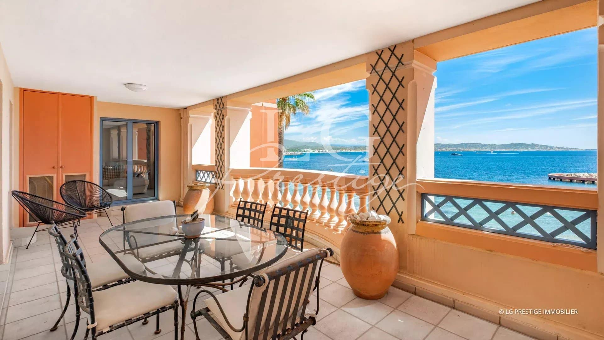 Terrace of an apartment with sea view in Théoule-sur-Mer, glass and metal garden furniture.