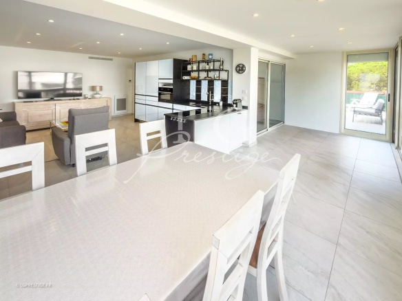 Interior of a modern apartment with a bright living room and open kitchen, in Mandelieu-la-Napoule.