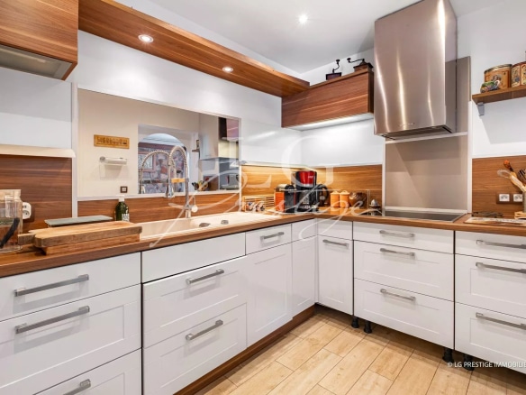 Cuisine moderne d'une maison jumelée à Mougins, avec plans de travail en bois et équipements intégrés.