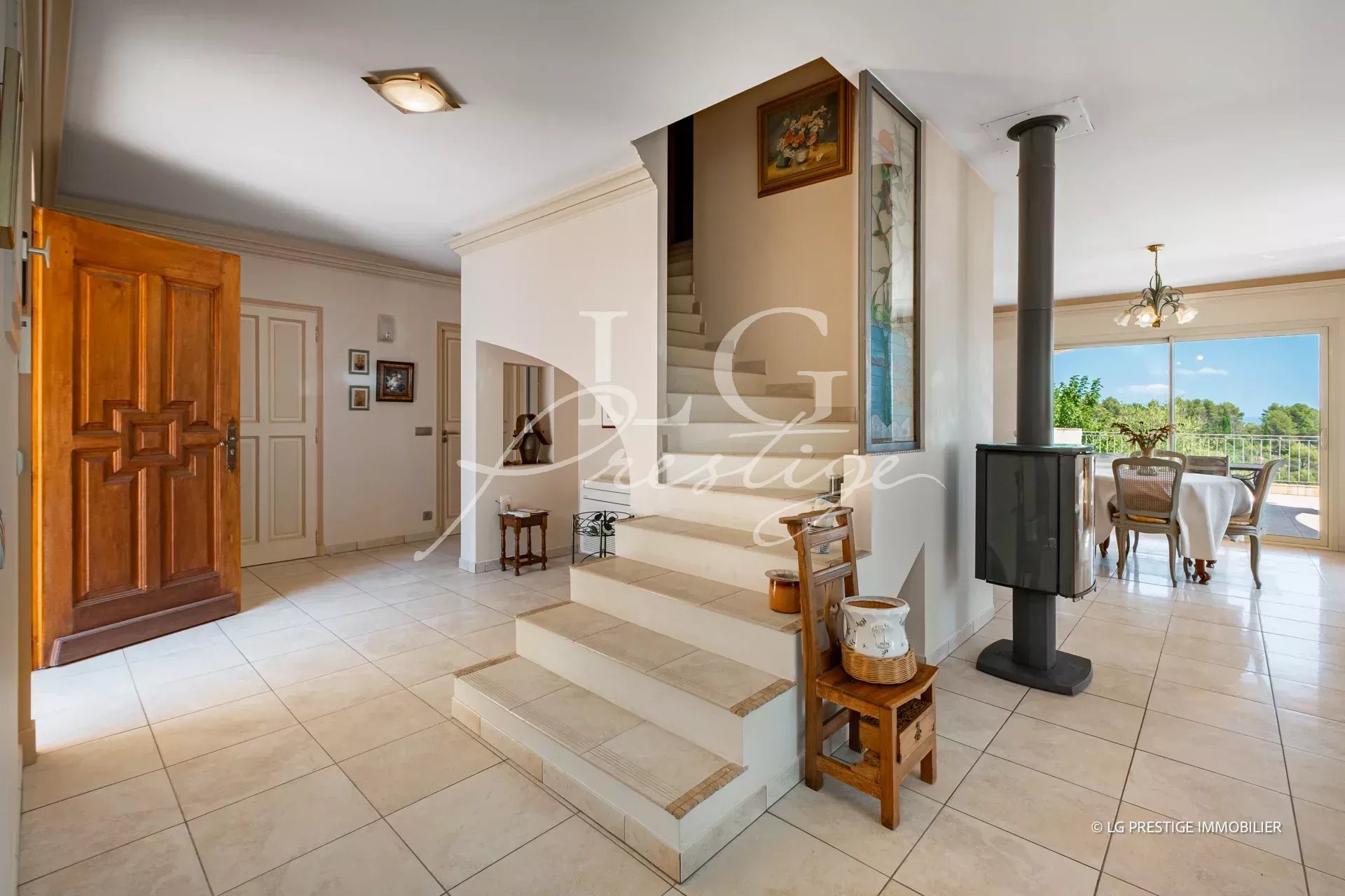 Intérieur d'une villa provençale avec un escalier et un coin repas lumineux.