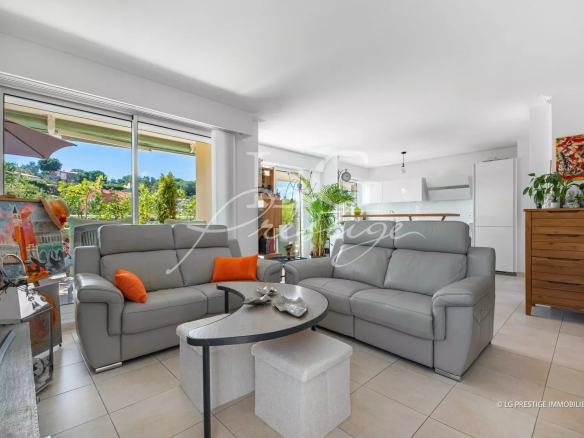 Interior of a modern apartment with a bright living room and open kitchen in Mandelieu-la-Napoule.