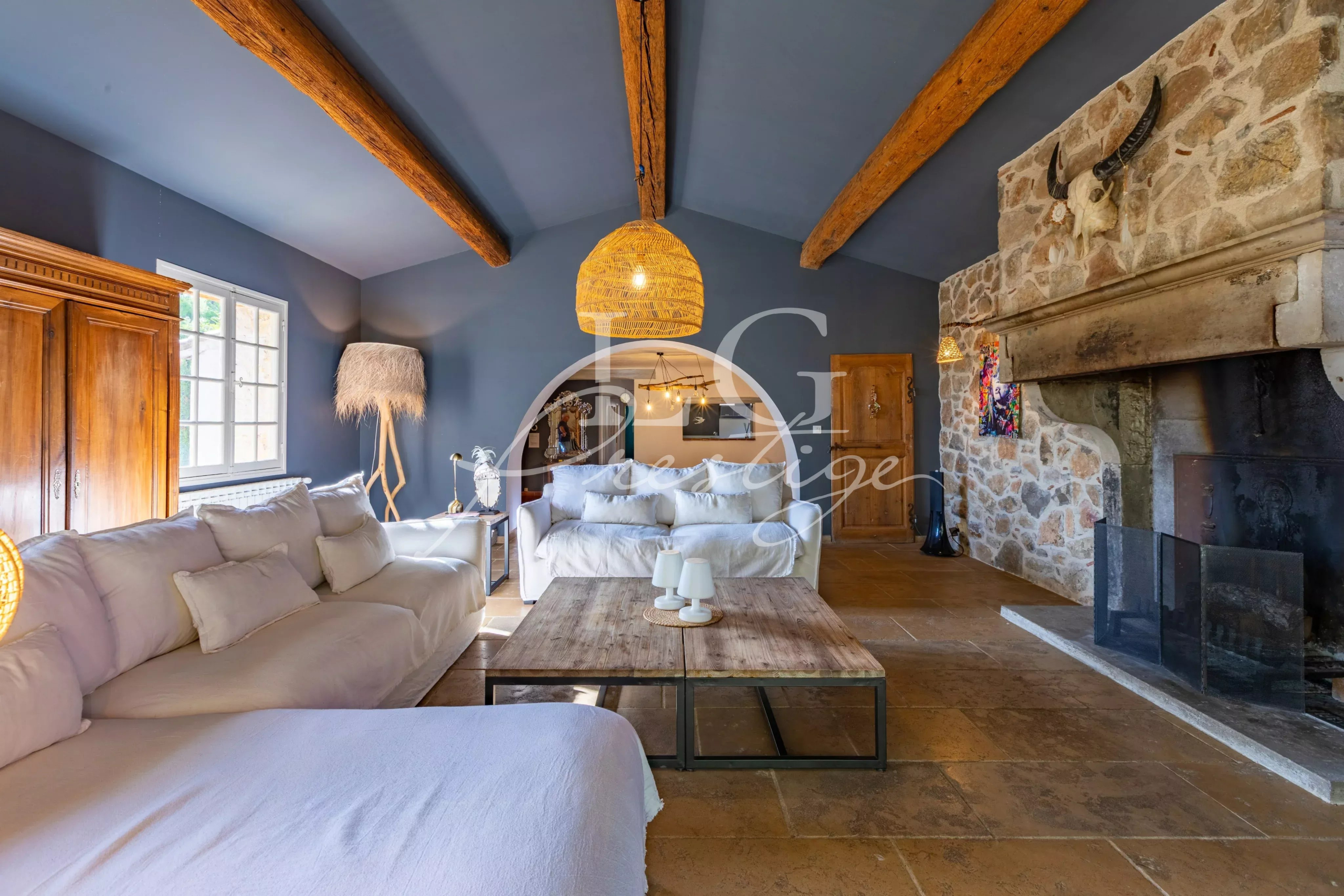 Interior of a Provençal villa Interior of a Provençal villa with a bright living room, fireplace and exposed beams.
