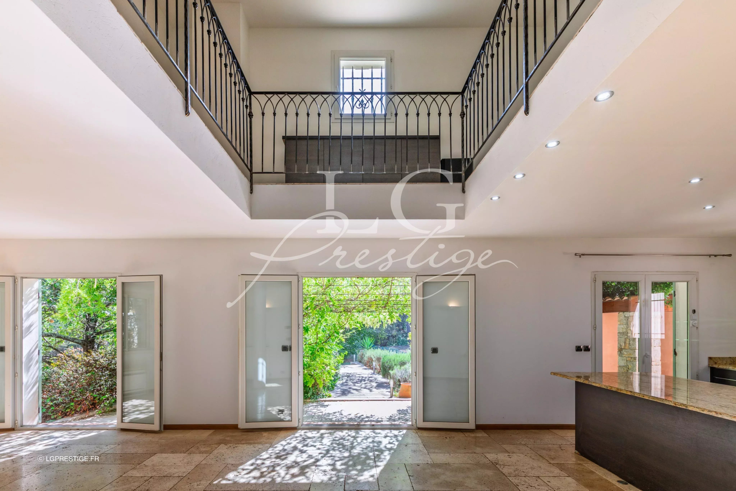 Intérieur d’une bastide provençale à Fayence Intérieur d'une bastide provençale avec un espace ouvert et des portes vitrées donnant sur le jardin.