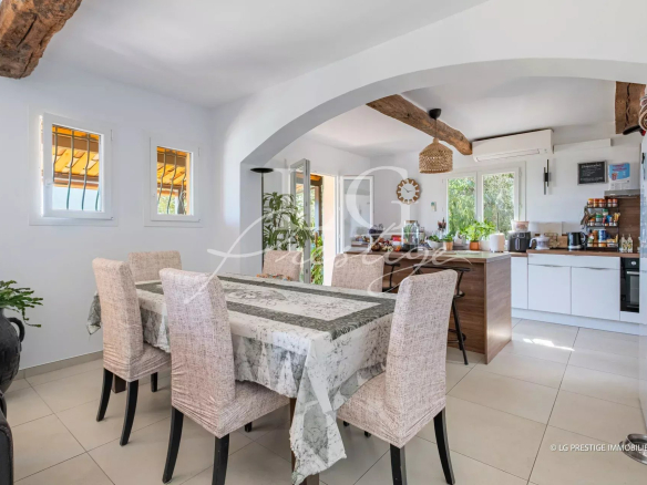 Interior of a modern villa with dining room and open kitchen, tastefully decorated.