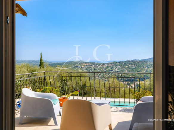 View from inside a villa with swimming pool, modern furniture and seascape in the background.