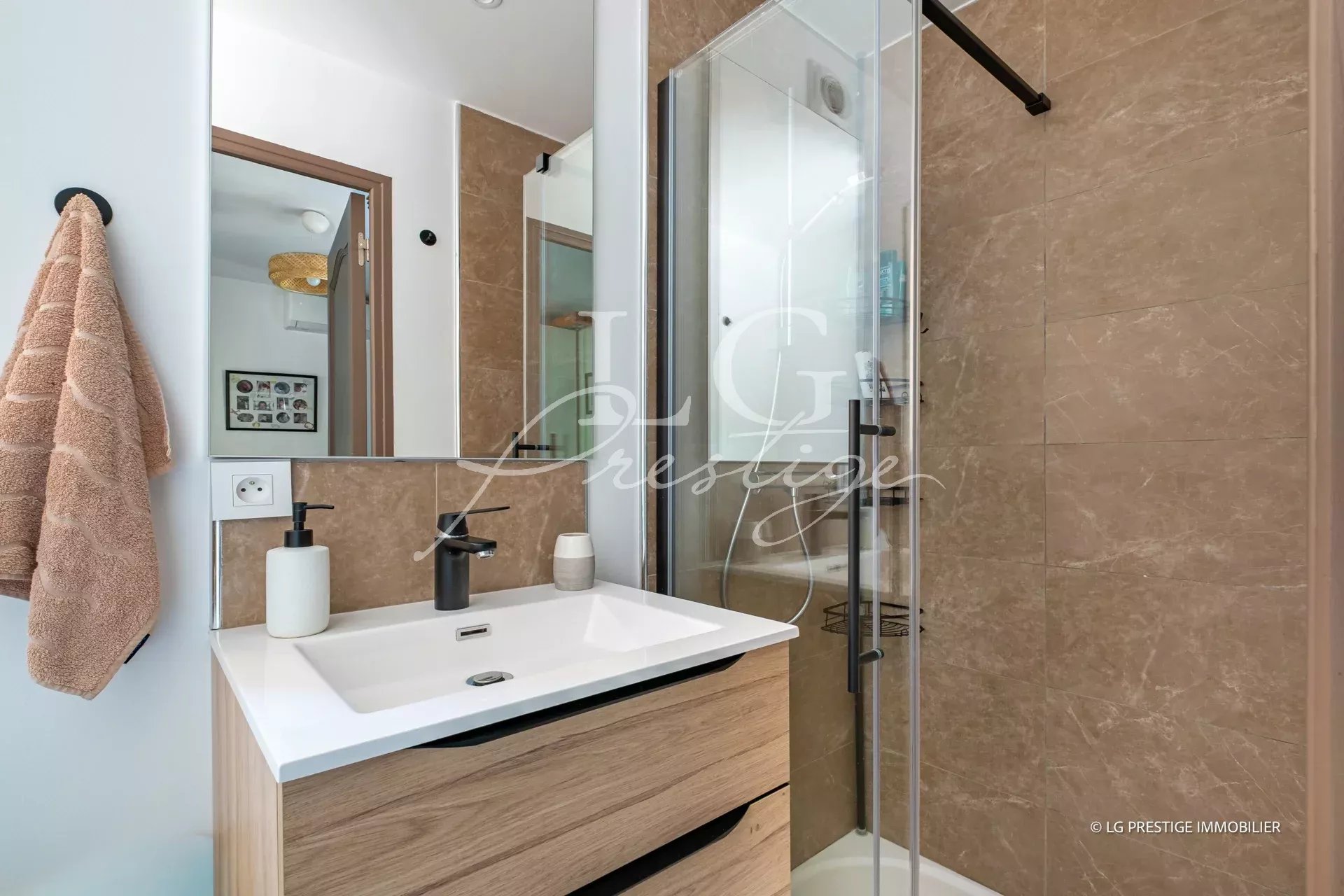 Modern bathroom Modern bathroom with shower, sink and mirror in a renovated villa.