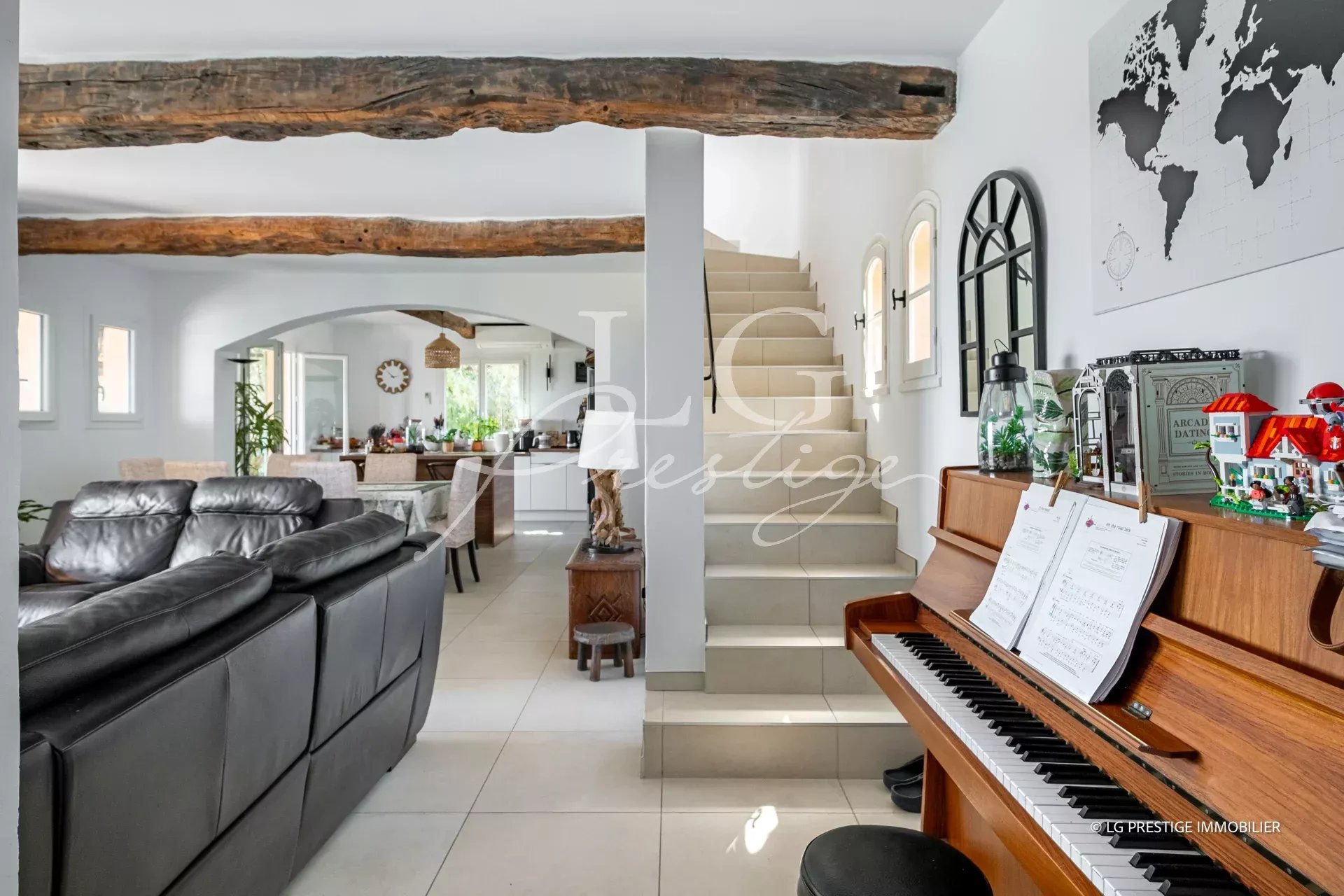 Interior of a villa in Spéracèdes Interior of a renovated villa with living room, piano and staircase, sea view.