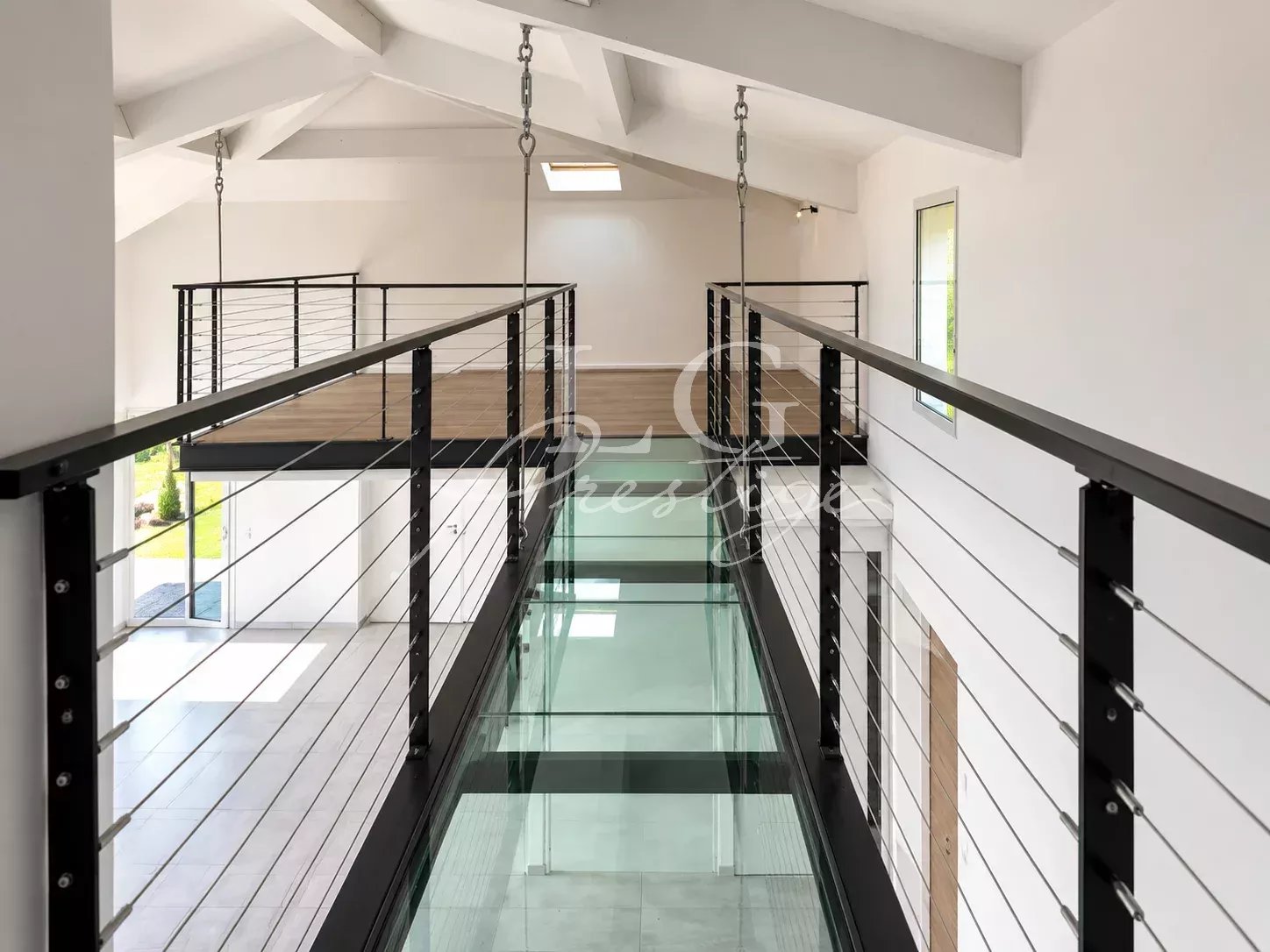 Interior of a contemporary villa Interior of a contemporary villa with mezzanine and suspended walkway.