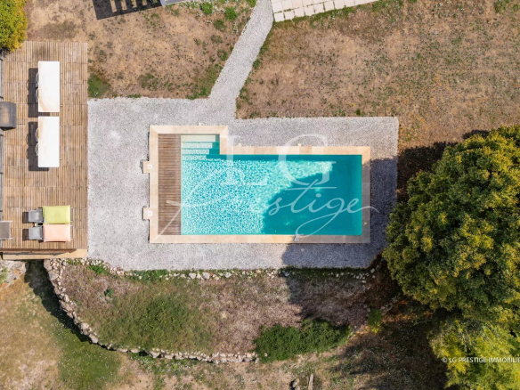 Aerial view of a swimming pool surrounded by garden in a contemporary villa in Montauroux.