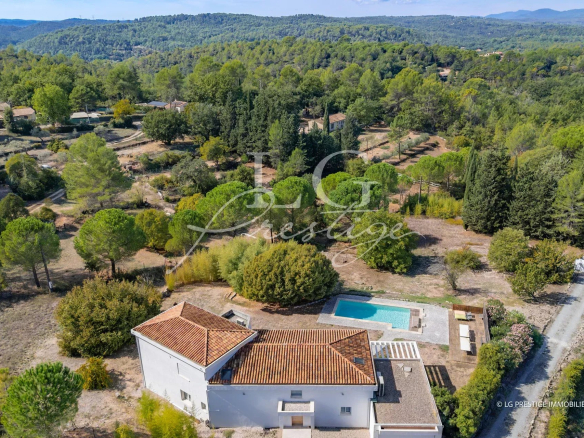 Aerial view of a contemporary villa with swimming pool in Montauroux, surrounded by greenery.
