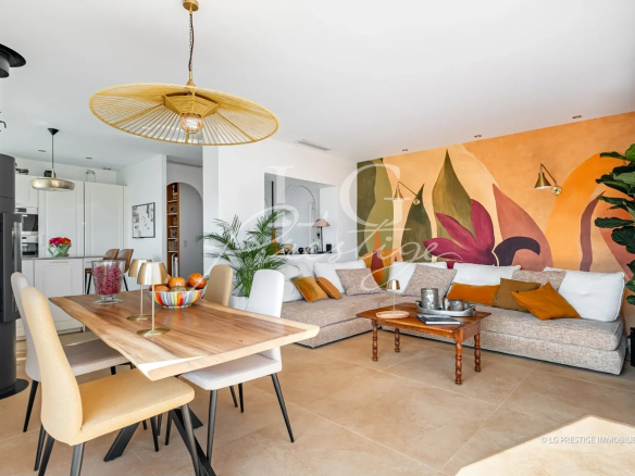 Interior of a renovated villa with a bright living room, dining table and modern decor.