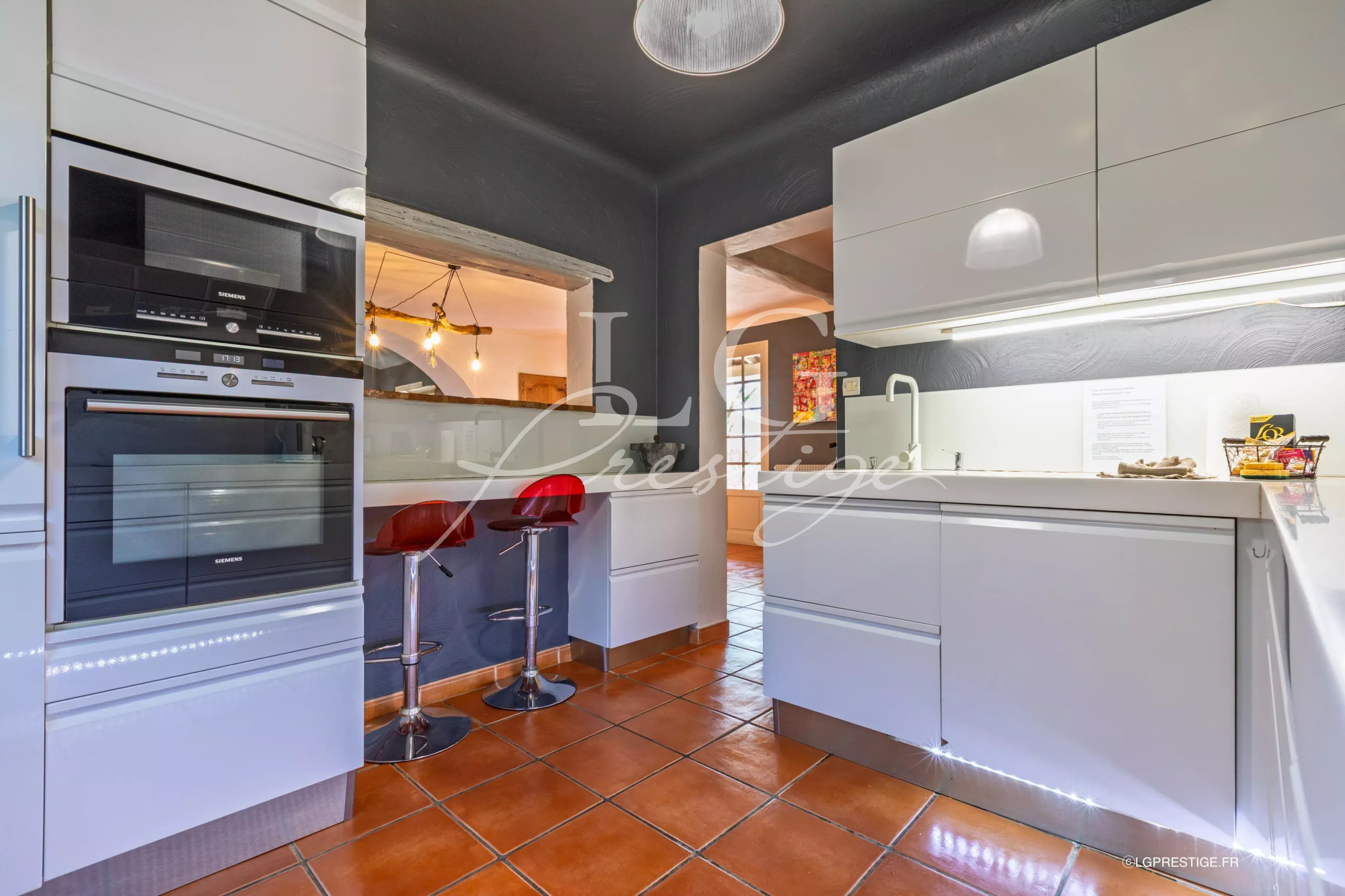 Kitchen of a villa in Seillans Modern kitchen in a Provençal villa with integrated bar and appliances.