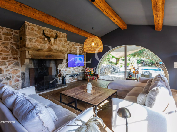 Interior of a Provençal villa with fireplace and bright living room.