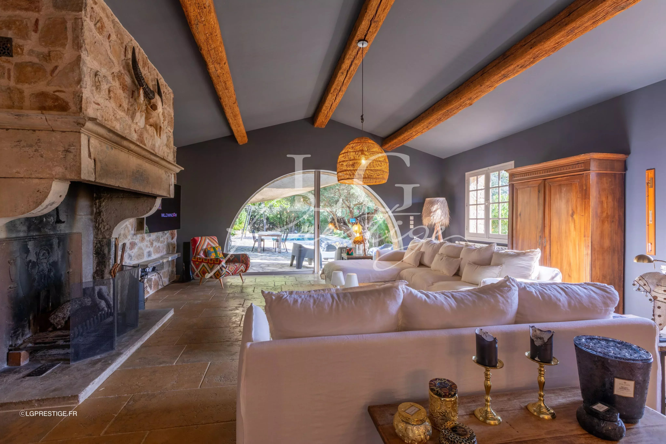 Interior of a villa in Seillans Interior of a Provençal villa with fireplace, white sofas and large windows.