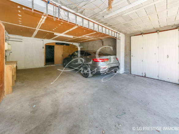 Spacious garage of a villa in Mandelieu-la-Napoule with a car inside.