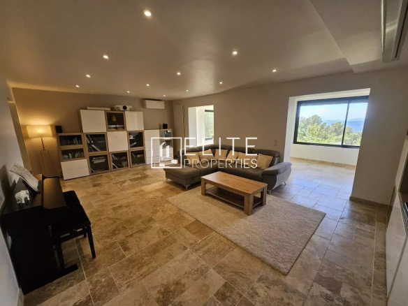 Interior of a spacious house with a bright living room and a view of nature.