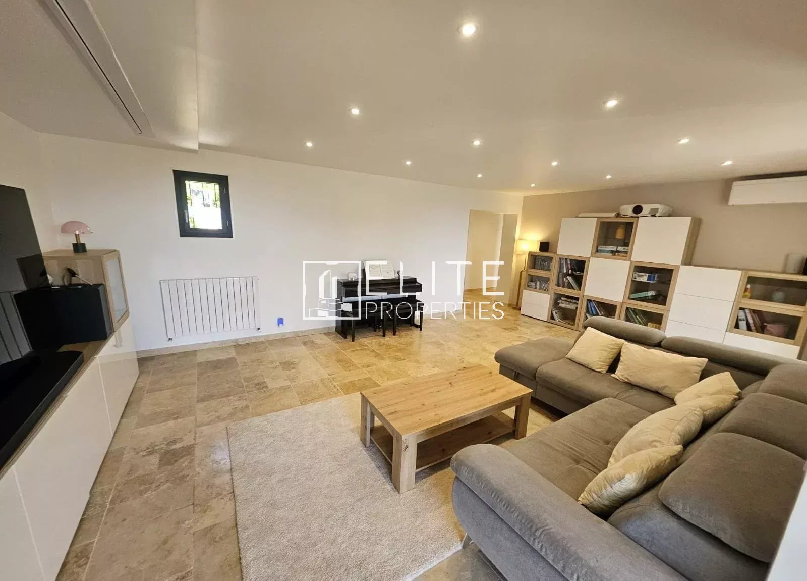 Interior of a spacious house with a bright living room and a comfortable sofa.