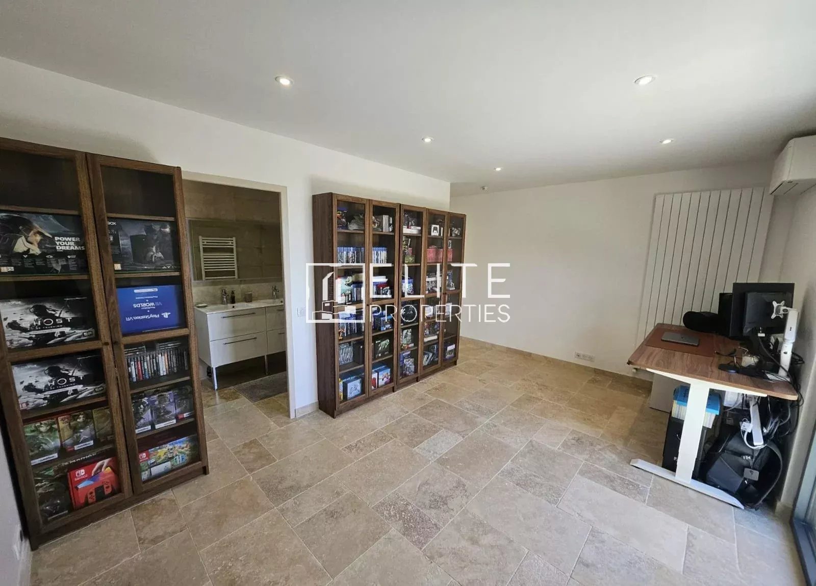 Interior of a house in Cabris with shelves and a desk.
