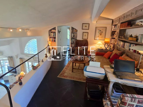 Interior of a house with living room, library and office, natural light, warm style.