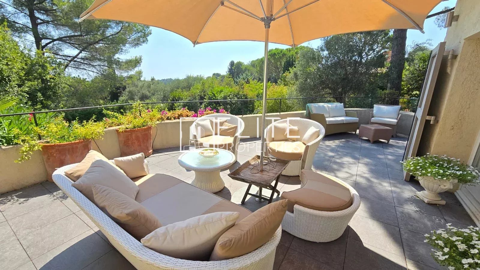 House terrace in Mouans-Sartoux Terrace of a house in Mouans-Sartoux with garden furniture and parasol, view of the hills.