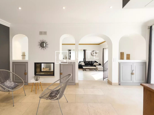 Interior of a modern villa with fireplace and sitting area in Grasse