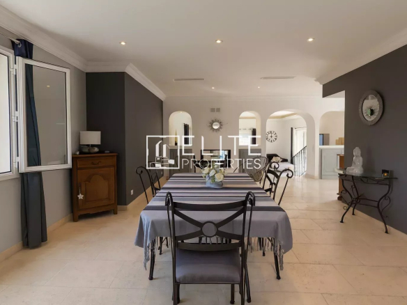 Interior of a modern villa with a spacious dining room and bright windows.