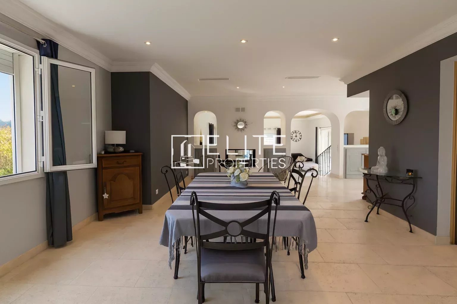 Interior of a modern villa with a spacious dining room and bright windows.
