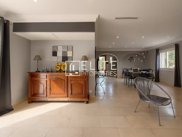 Interior of a modern villa with a bright living room and wooden furniture, located in Grasse.