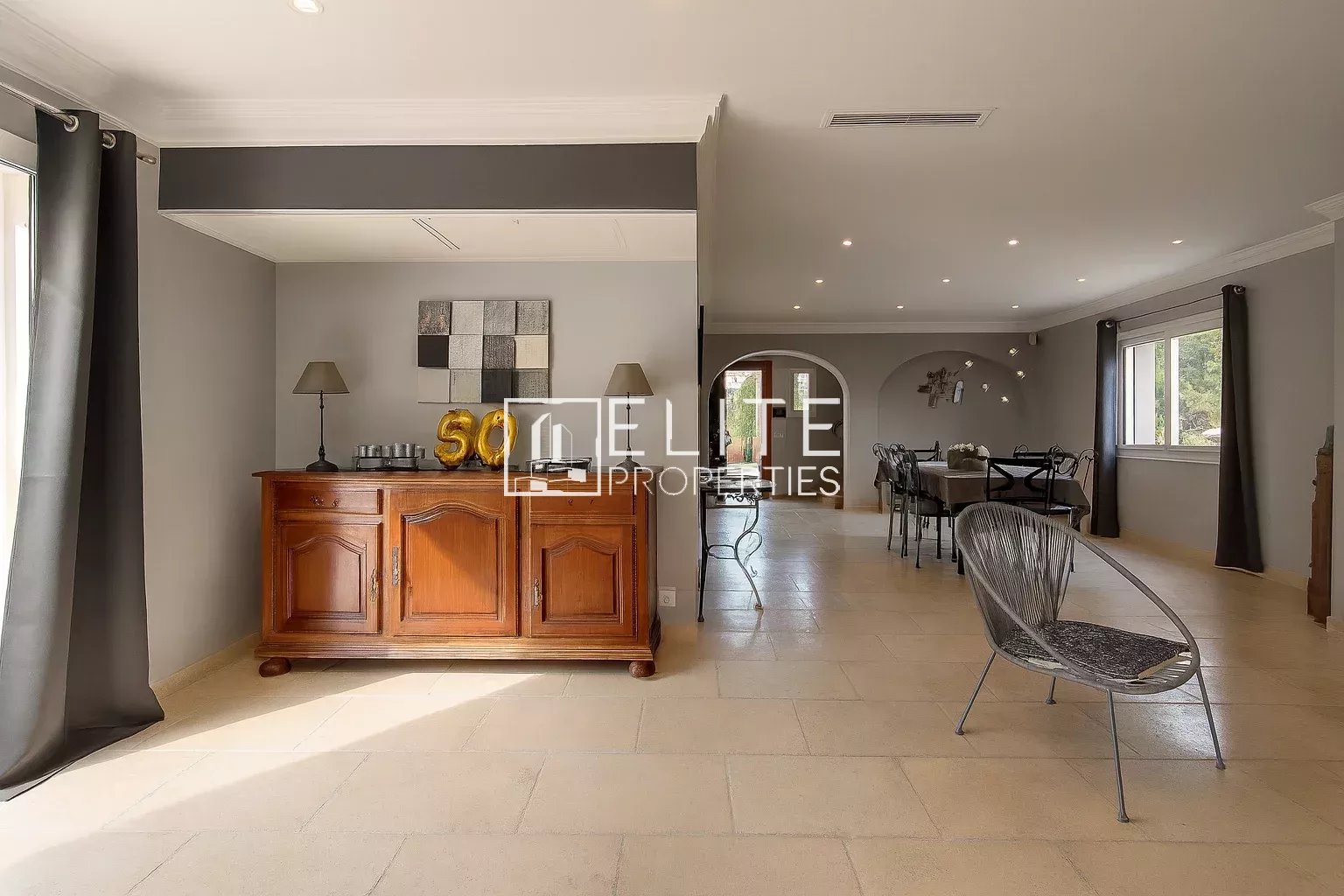 Interior of a modern villa with a bright living room and wooden furniture, located in Grasse.