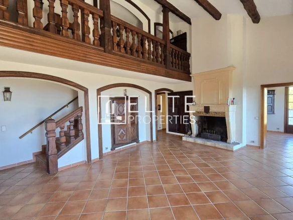 Interior of a 155 m² house with fireplace and staircase, in Mandelieu-la-Napoule.