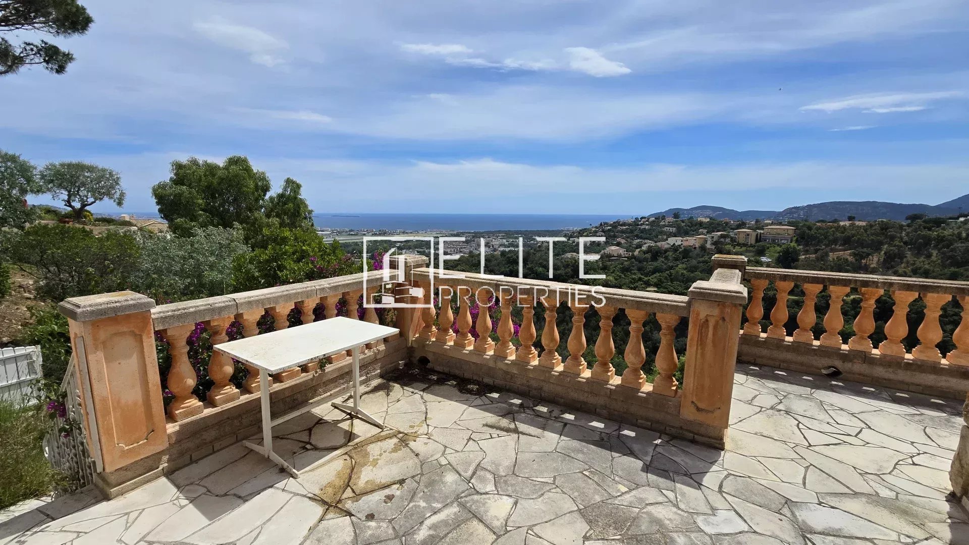 Terrace with panoramic views Terrace with sea view in Mandelieu-la-Napoule, garden furniture visible.