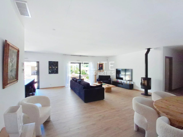 Interior of a renovated villa in Vallauris, with a spacious living room and fireplace.