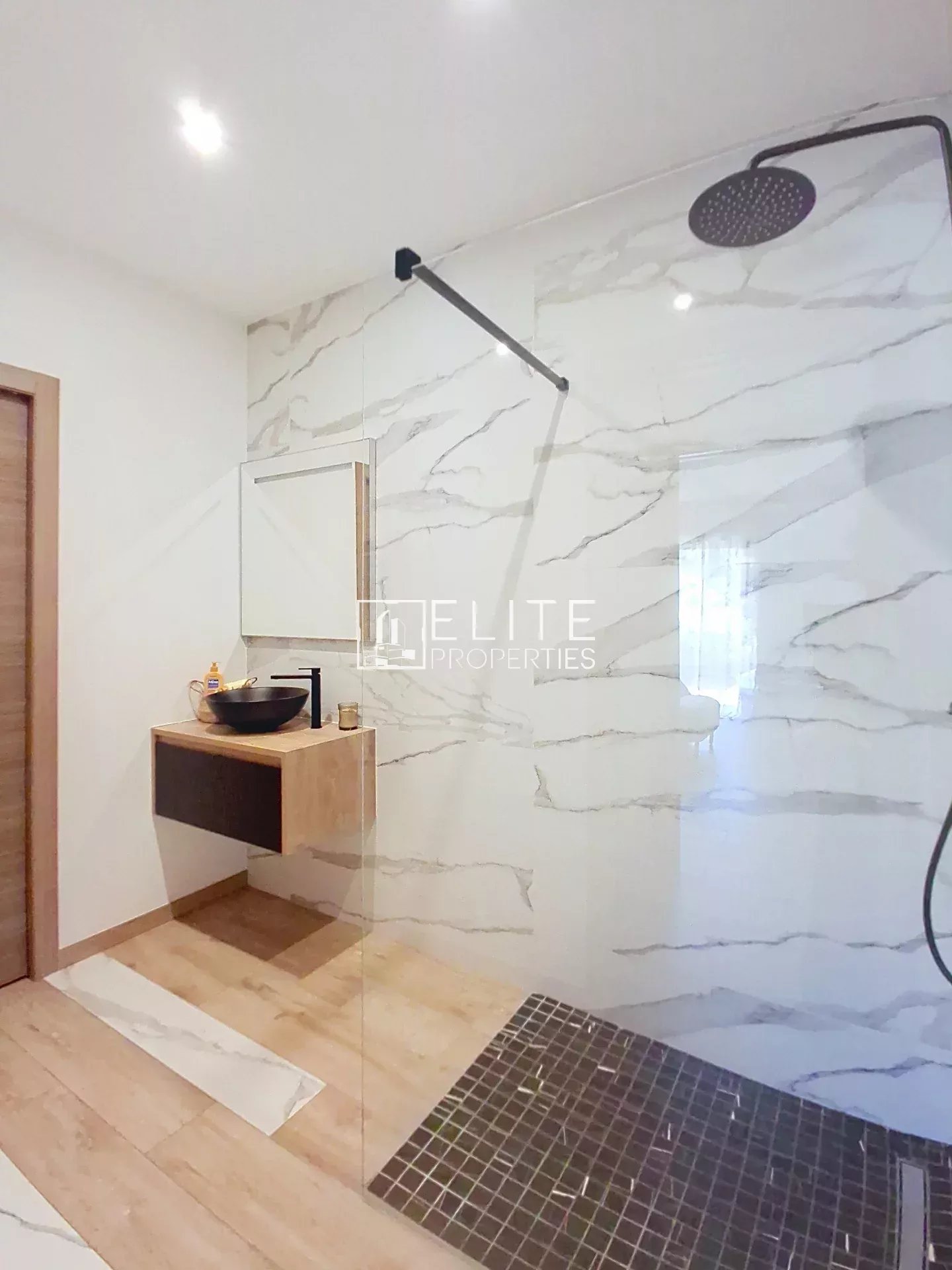 Elegant bathroom Modern bathroom with walk-in shower and wooden vanity.