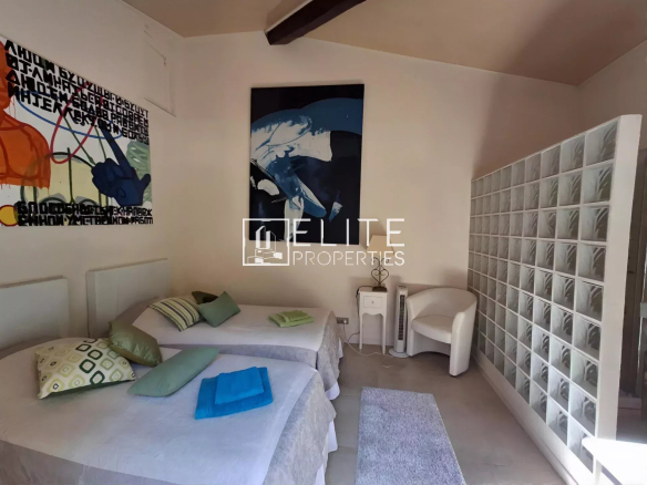 Villa room with twin beds and modern decor.