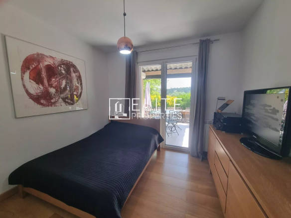 Chambre d'une maison de plain-pied à Grasse, avec accès à une terrasse extérieure.