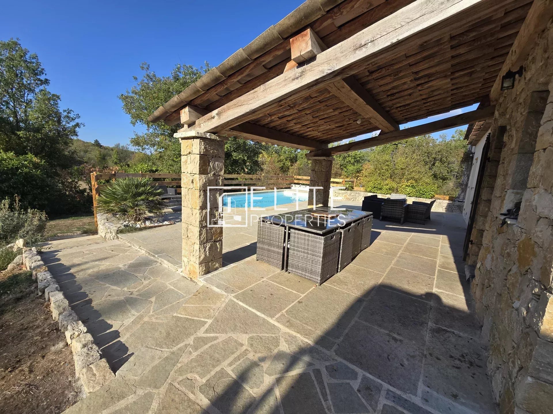 Terrasse en pierre avec mobilier de jardin dans une maison à Saint-Vallier-de-Thiey.
