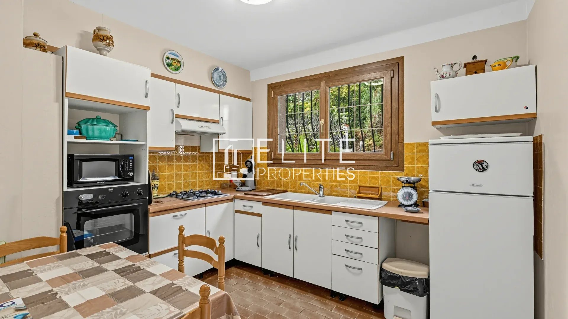 Kitchen to renovate in Mandelieu-la-Napoule Kitchen of a house to be renovated in Mandelieu-la-Napoule, with white furniture and tiled floor.