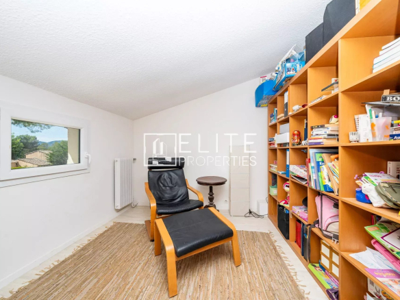 Intérieur d'une maison avec un fauteuil et une bibliothèque, Grasse Saint-Jacques.