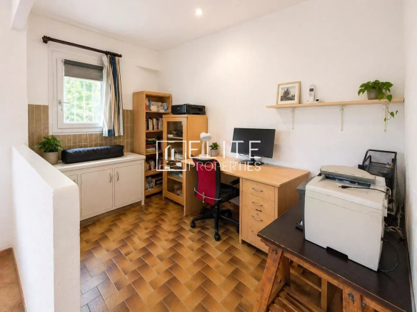 Office in a house in La Roquette-sur-Siagne with wooden furniture and storage space.