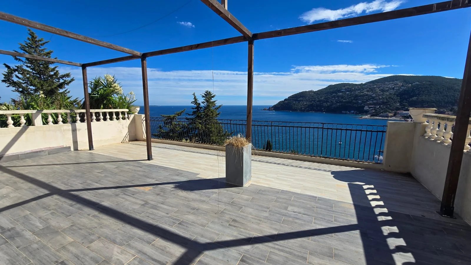 Terrasse avec vue sur la mer à Théoule-sur-Mer Terrasse avec vue panoramique sur la mer à Théoule-sur-Mer, entourée de végétation.