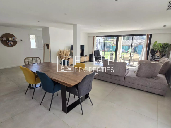 Intérieur d'une maison rénovée avec un séjour spacieux et une salle à manger.